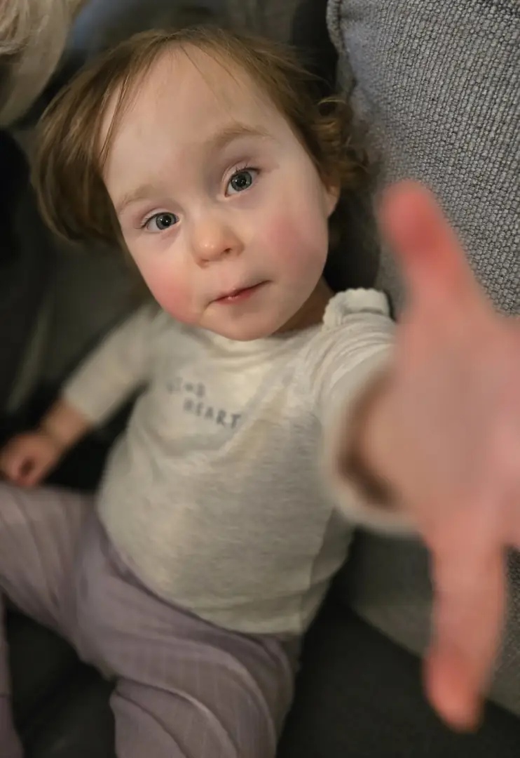 Charli reaching toward the camera.